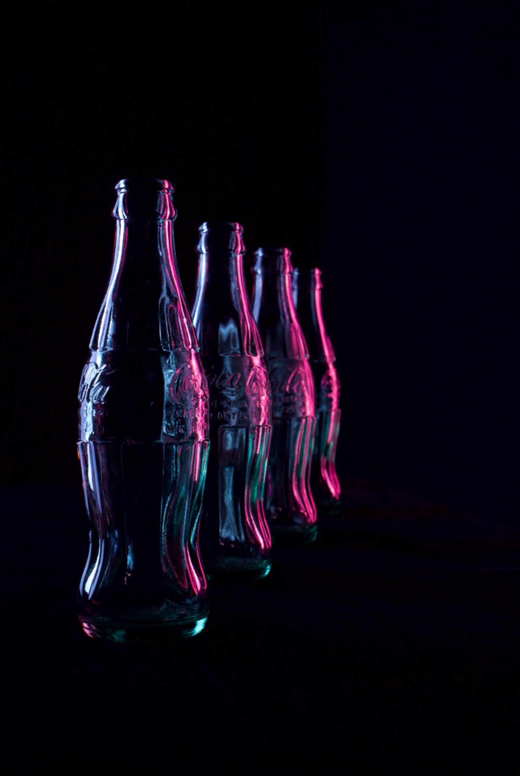 image of four bottles lined up with dark background